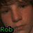 Pixelated close-up of a person's face with brown hair and a green eye, featuring green text reading 'Rob' at the bottom left.