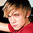 A pixelated image of a person in a red shirt with orange text reading 'So' and 'Hot!' on black background.
