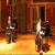 Animated contact sheet showing 16 sequential frames of a pixel-art icon featuring a running stick figure and text elements on an orange background with wooden paneling.
