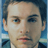 Static 48x48 pixel icon of a person's face with light skin tone, dark hair, and blue eyes against a blurred background.