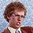 A pixelated image of a person with curly brown hair wearing glasses and a white collared shirt under a dark jacket, next to black pixelated text reading "You wanna play me?" on a light blue background.