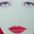 Pixelated close-up of a face showing blue eyes, red lips, and light skin tones against a pale background.