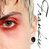 Close-up of a person's face showing eye with red eyeshadow, short light-colored hair, black ear gauge, and handwritten text on the right side.