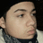 Pixelated close-up of a person's face with light skin tone, dark eyebrows, and closed eyes against black background.