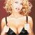 Pixelated image of a person with light brown curly hair wearing a black strapless top against a solid brown background.