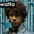 A pixelated image of a person with curly brown hair against a blue striped background, featuring text overlays and an animated expression change.
