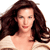 Pixelated image of a person with long brown hair wearing a light-colored top against a white background.