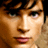 Pixelated close-up of a person's face with text "clark kent" and "smallville" on black background, part of an animated contact sheet frame.