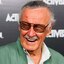 Static 64x64 pixel icon showing a smiling older man with glasses wearing a green jacket over a white shirt, set against a dark background with partial text elements.