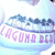 A light blue circular icon with a purple text band reading "LAGUNA BEACH" and a dark blue mountain silhouette above the text.