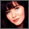 A sequence of pixelated images showing a figure with dark hair transitioning from realistic to cartoonish style, with changing facial features and background colors.