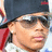Pixelated image of a person wearing dark sunglasses and a black cap with red accents, next to bold white text on a solid red background.