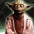 Static pixelated image of a small green-skinned character with large ears wearing brown robes against a dark background.