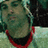Pixelated image of a person with light hair and a red-collared shirt, split into four quadrants with red and gray backgrounds and white text.