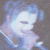 A pixelated animated image shows a person with light blue hair transitioning from a neutral expression to an open-mouthed pose against dark backgrounds.
