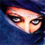 Pixelated close-up of a face with light skin tone, dark eyes, and dark eyebrows against a blue background.