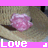 A static image of a pink flower on a straw hat with text labels below.