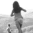 A grayscale image of a woman running on a beach with a child, overlaid with blue text expressing affection for someone who makes you smile.