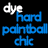 Static image with black background displaying 'dye' in white and 'hard paintball chic' in blue pixelated text, alongside a light blue shield-like shape on white background.
