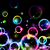 Colorful glowing circles float against a black background with a bright multicolored wave at the bottom.