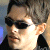 Pixelated image of a person with short hair and sunglasses on the left, next to green text reading "Original Icons .com" on a dark background.