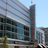 Pixelated image of a modern building with glass and concrete elements under a clear sky.