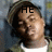 A pixelated image of a person wearing a cap and white shirt with text overlays changing across frames.