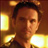 Pixelated close-up of a person with dark hair against a warm-toned background with glowing rectangular elements.