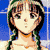 Pixelated image of a person with dark brown hair styled in two braids, wearing a green and white patterned headband and an orange necklace against a blue background.