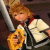 Pixelated image of a character with light brown hair holding two objects: one yellow and one white, against dark background.