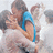 A pixelated image of two people embracing, with text overlays reading "True Love" and "Never dies <3" on a light blue background.
