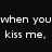 Black background with white text reading 'when you kiss me, my heart blows fireworks' next to a person in dark clothing holding a child near a colorful explosion.