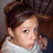 A pixelated image shows a person with brown hair and light skin wearing a white top, next to pink text reading 'Ashley' followed by two heart symbols.
