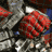 Animated sequence showing a red and silver armored figure's hand gripping a weapon, transitioning to the character's face with visible eyes and helmet details against a blue background.