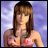 Pixelated image of a person with long brown hair wearing a pink floral bikini top against a blue sky background, next to text reading "Anime IM" and "com" on black.