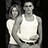 Black-and-white pixelated image of two people in a close embrace, with text elements surrounding the central figure.