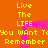 A static digital image with bright orange background, yellow pixelated text repeating 'Live The LIFE', and pink glowing vertical lines forming a frame-like structure.