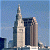 A pixelated image of a tall building with a spire against a blue sky, next to green text reading 'Original Icons .com' on a dark background.