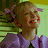 Animated contact sheet of a cartoon girl with blonde pigtails in purple bows, wearing a purple dress with ruffled collar, against green striped background, showing mouth animation across frames.