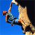 Pixelated static icon of a stick figure climbing with a rope against blue and black background.
