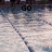 A pixelated image with text overlays reading 'GO', 'CLUB', and 'WOLVERINE!' on a blurred background of light-colored pavement and dark lines.