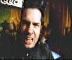 A person in a dark jacket with blue accents appears in three showing facial expression changes from grimace to smile