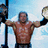 A pixelated image of a shirtless man holding two large objects, with text reading "Its time to play the game!" on the right side.
