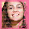 A static image shows a person with long brown hair against a solid pink background, wearing a pink top with a visible heart-shaped detail on the right shoulder.