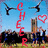 A pixelated image divided into four quadrants with text and graphics: cheerleaders, a heart symbol, and red text reading "CHEER," "DOWN WITH COACH E.," and "UP WITH.".