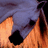 Pixelated image of a character with orange skin and blue hair partially covering the face, next to pink text reading 'Dare to dream' on dark background.