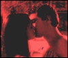 Animated sequence of two figures in red-toned frames showing gradual separation from a kiss, with text overlays at the bottom.