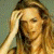 A pixelated image of a person with long light brown hair resting their head on one hand, next to green text reading 'Original Icons .com' on a dark background.
