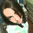 Pixelated image of a person with long dark hair wearing a white top, positioned next to green text on black background.