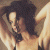 A pixelated image of a woman with dark hair lying down, next to green text reading 'Original Icons .com' on a solid background.